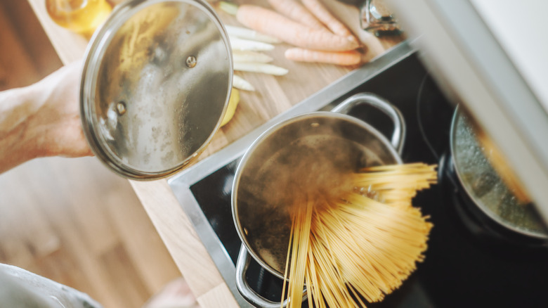 making spagehetti on a stovetop