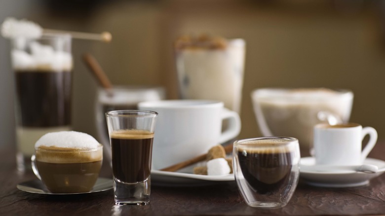 Table laden with fancy coffee shop coffee cups