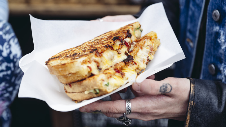 Person holding grilled cheese sandwich