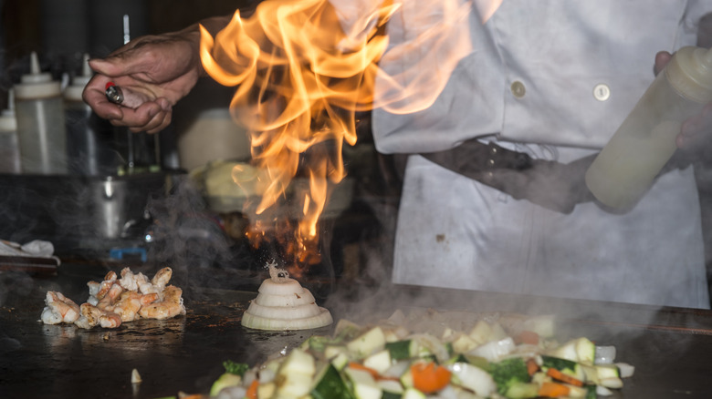 Chef lighting an onion volcano