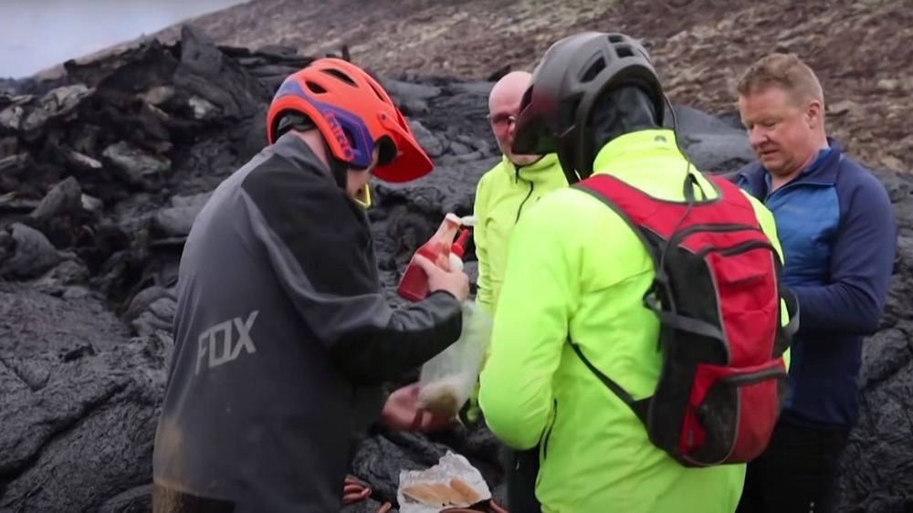 Icelandic people cooking hot dogs on lava