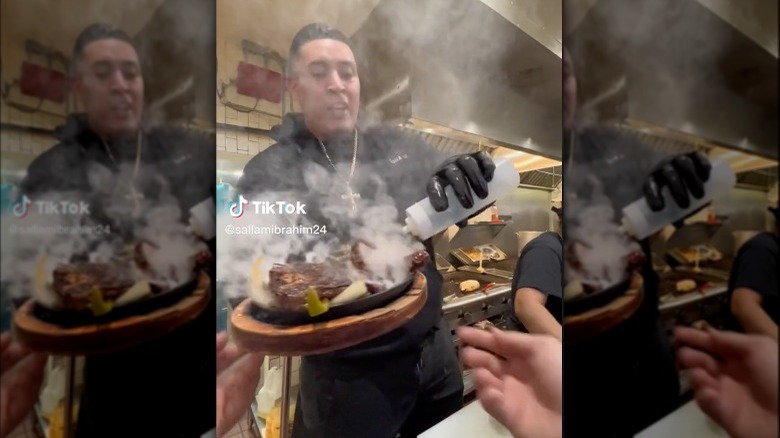 Restaurant employee sizzling fajitas 