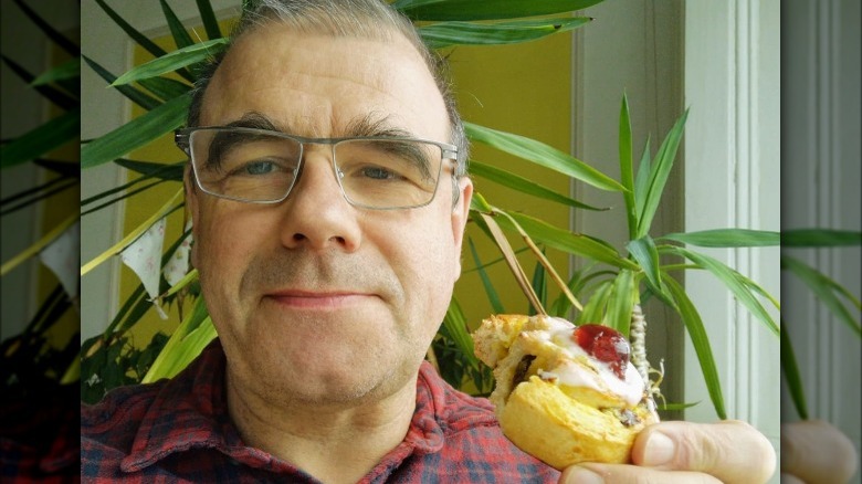 GBBO contestant Jurgen Krauss holding a cake