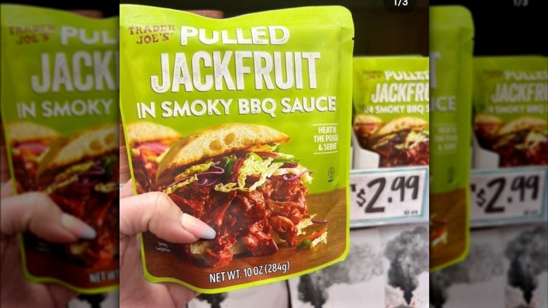 Hand holding Pulled Jackfruit in smoky BBQ sauce package