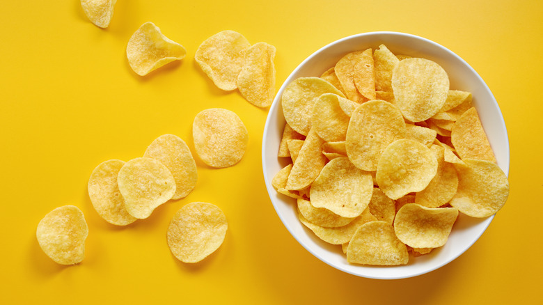 Bowl of chips on yellow background
