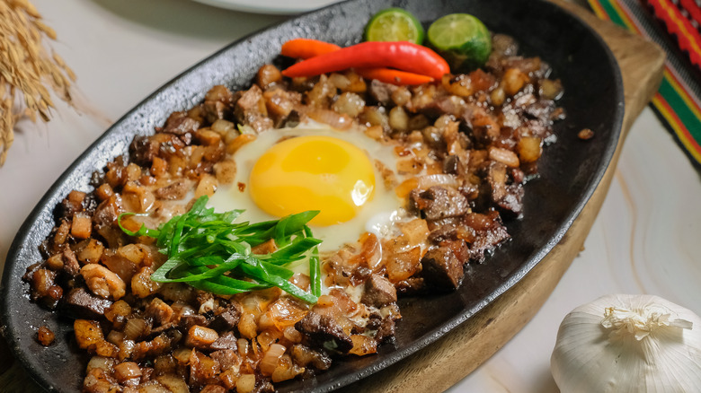 Sisig on hot plate with egg