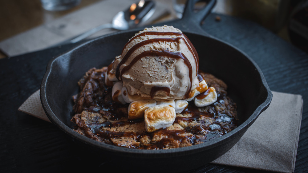 A skillet cookie topped with ice cream