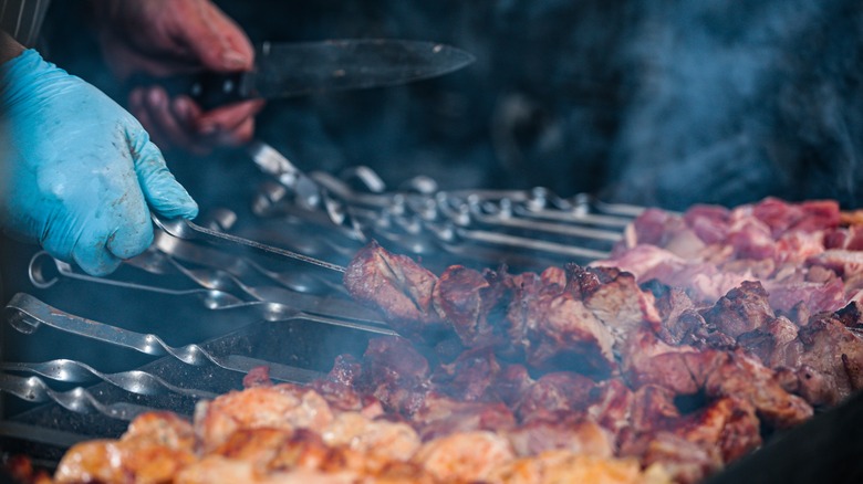 Skewers of meat on grill