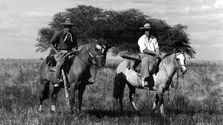 Black and white photo of Brazilian ranchers on horseback