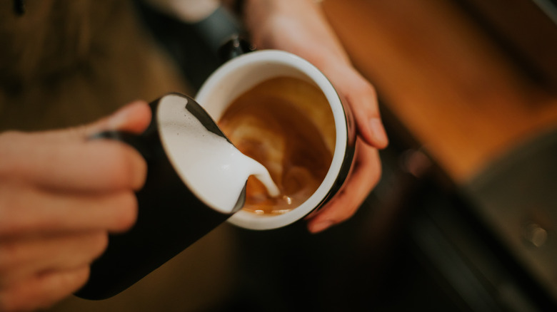 pouring cream in espresso 