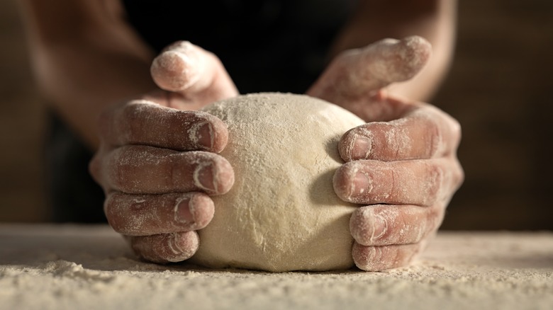 Kneading homemade pizza dough