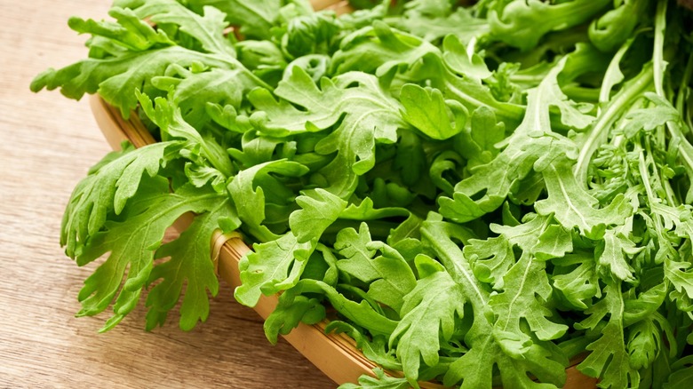 Chrysanthemum greens on a wooden tray