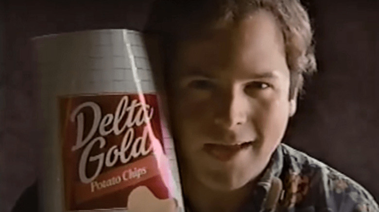 A young Jason Alexander holding a bag of Delta Gold potato chips