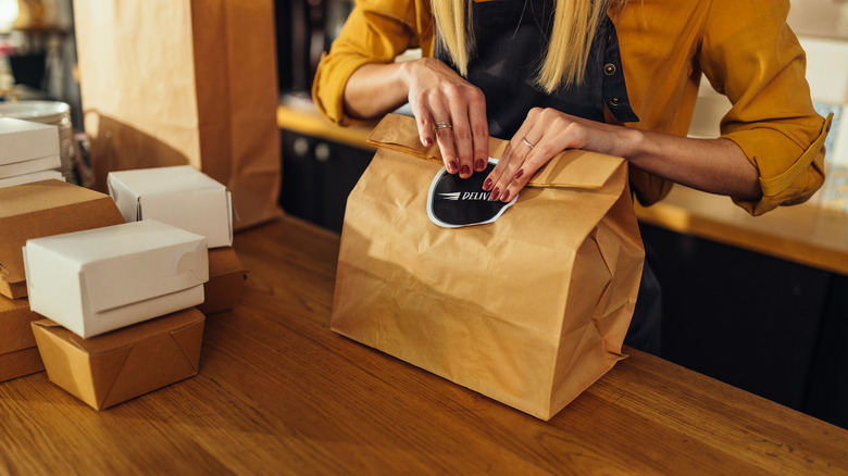 woman packing delivery food