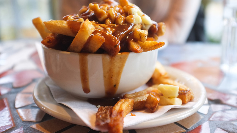 Overflowing bowl of poutine