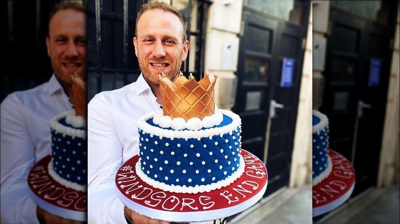 Steven Carter-Bailey holding royal-themed cake