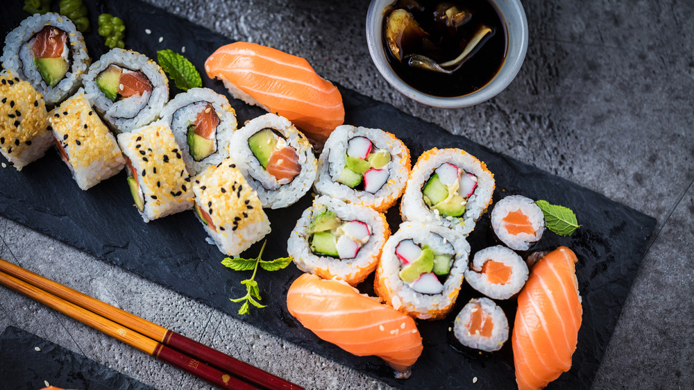 A black platter with sushi