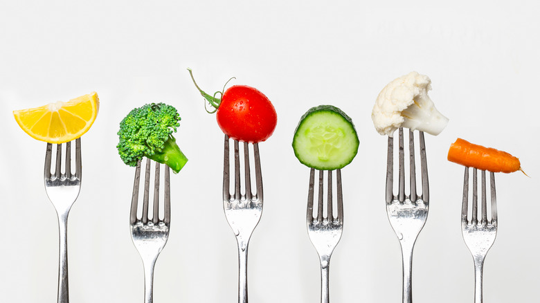 fruits and vegetables on forks