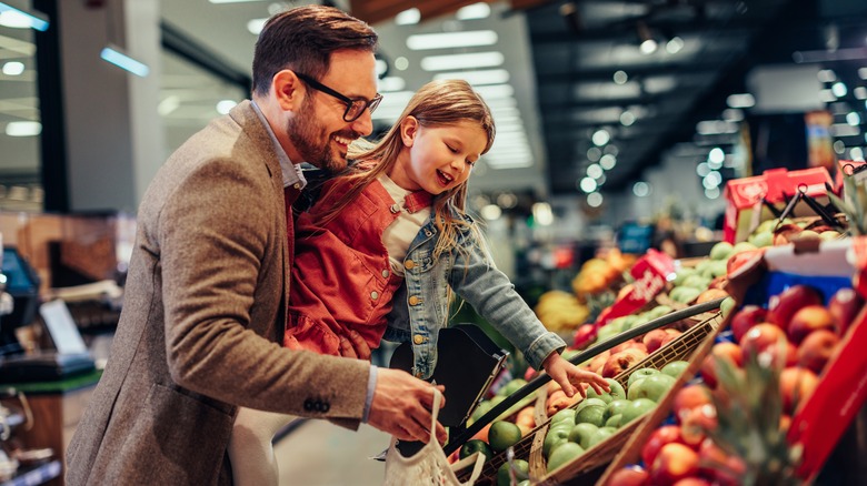 Father and daughter grocery shopping