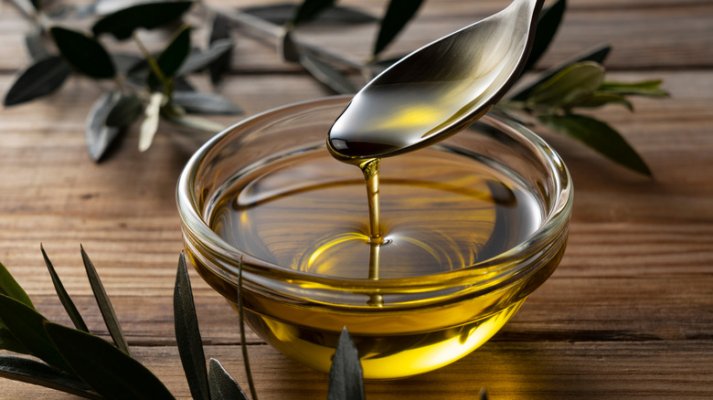 Bowl of olive oil with spoon in it