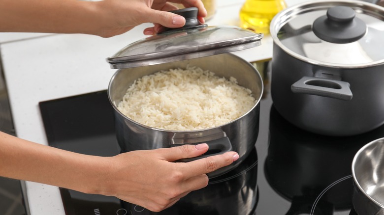 Woman cooking rice on stove