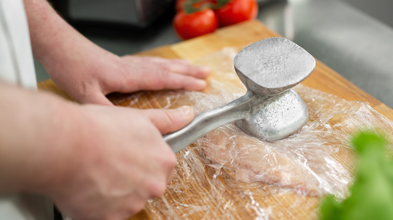 tenderizing chicken with a hammer