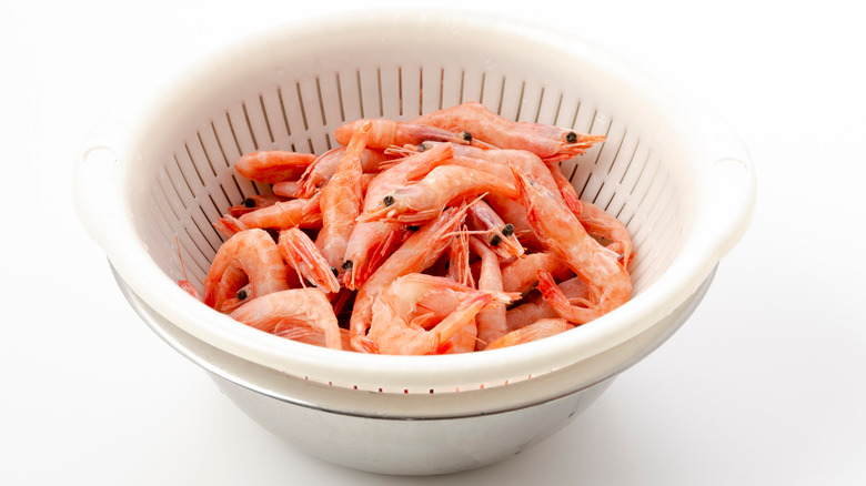 Frozen shrimp in colander