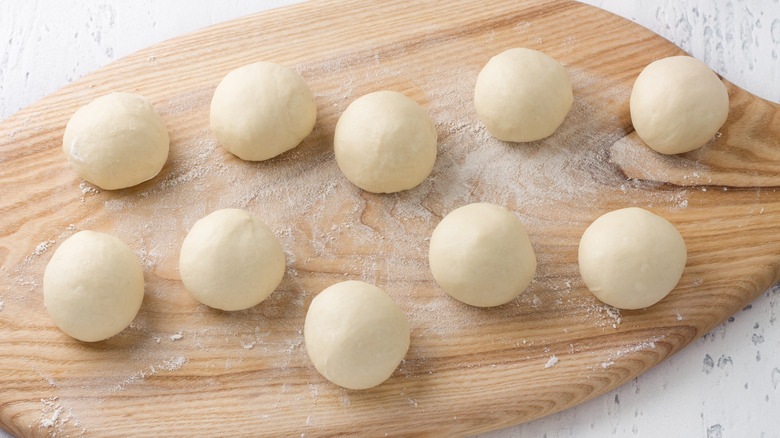 Rolled dough balls on cutting board