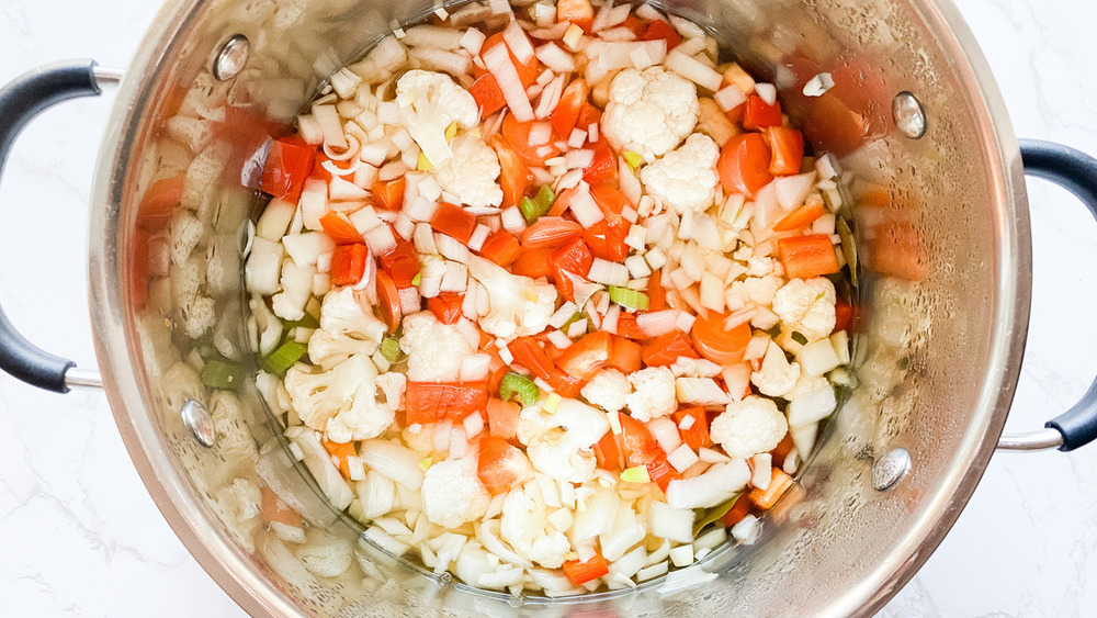 Pot of chopped vegetables cooking in liquid