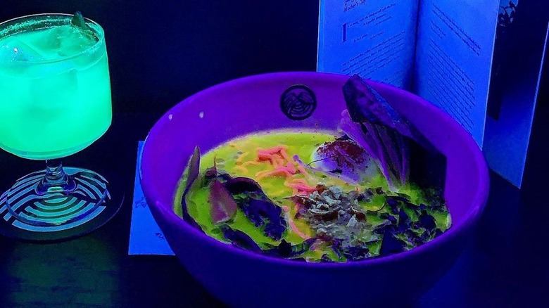 glow-in-the-dark ramen, luminescent cocktail, and booklet