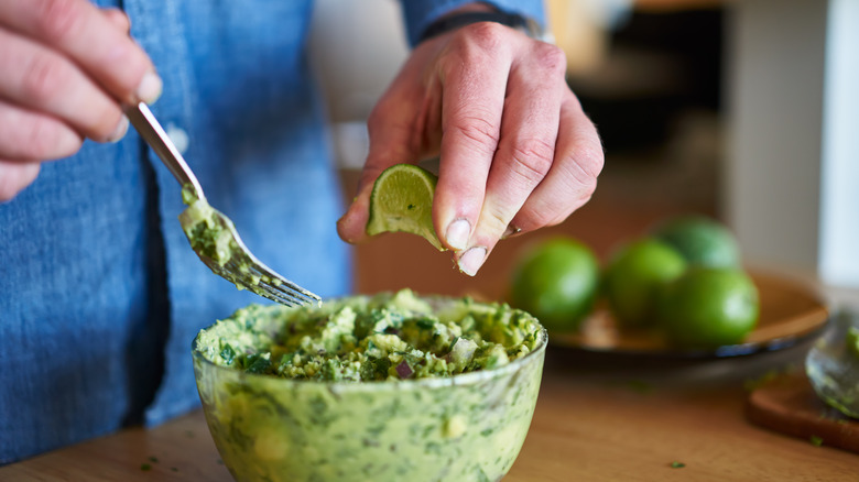 Squeezing lime into guacamole