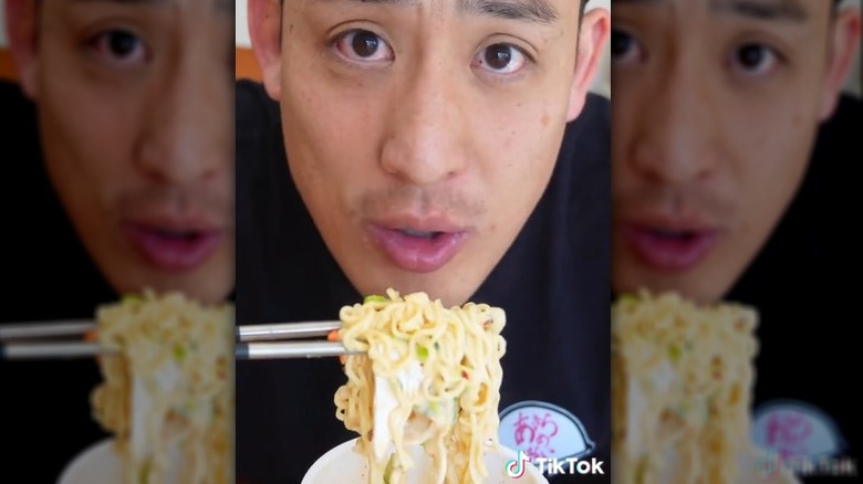 Person eating ramen with brie