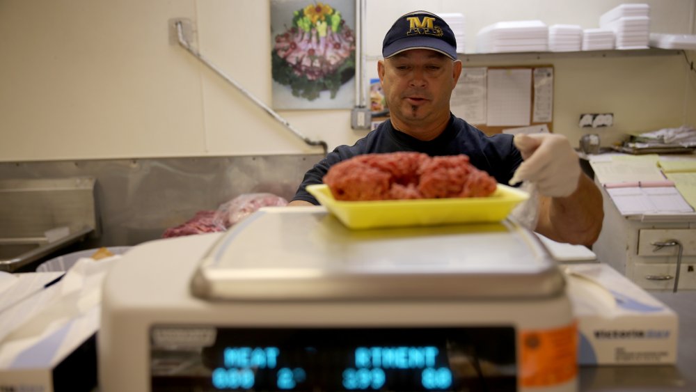 Man weighing ground beef