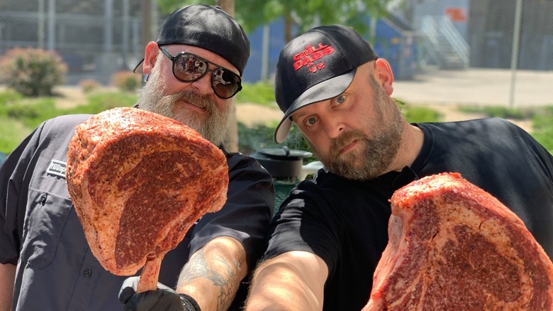 The Grill Dads holding meat