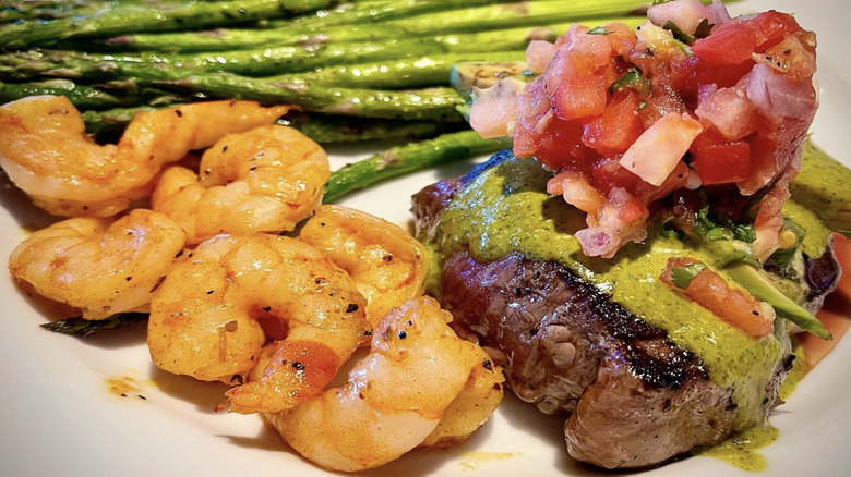 Shrimp, asparagus, and steak with toppings