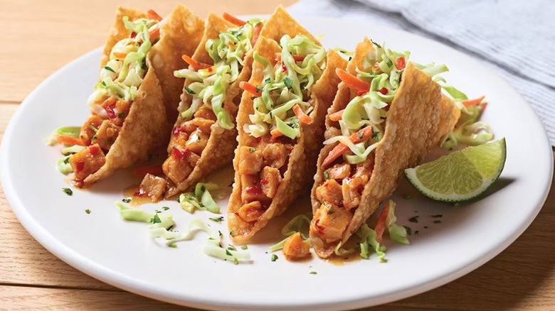 four chicken wonton tacos on plate