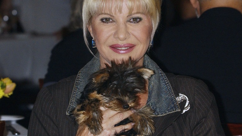 Ivana Trump smiling and holding small dog