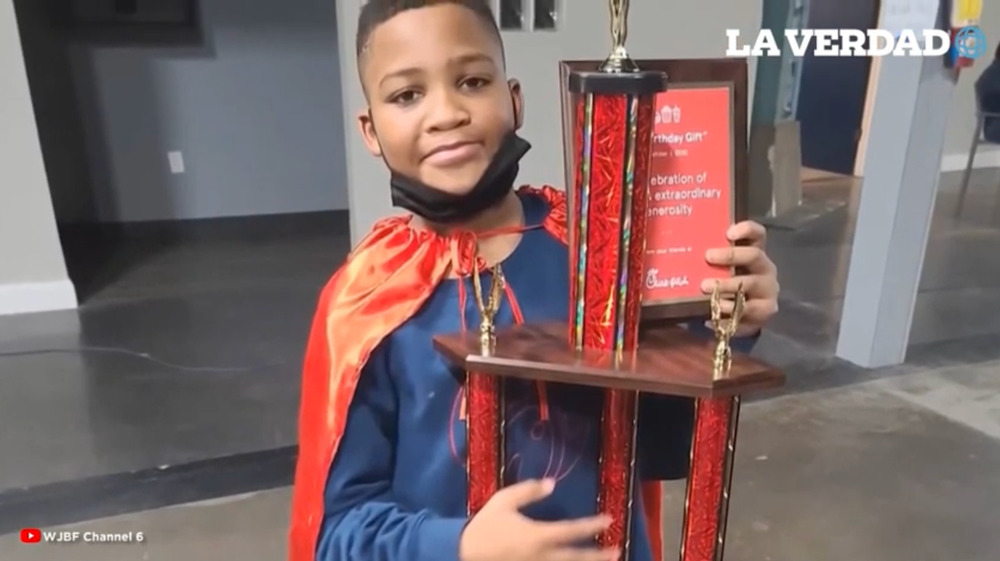 Brycen Gault holding Chick-fil-A trophy