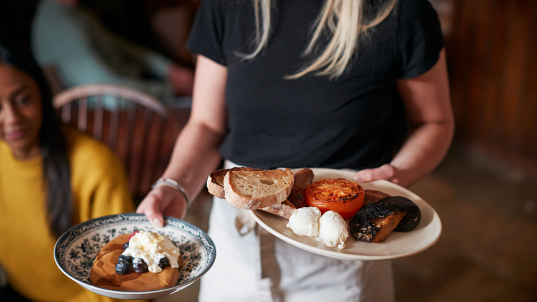 Waitress serving breakfast