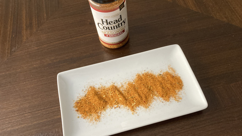 A Head Country container standing near a platter of seasoning