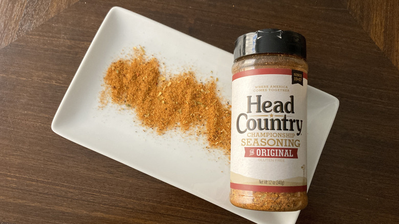 A container of Head Country seasoning lying on a platter