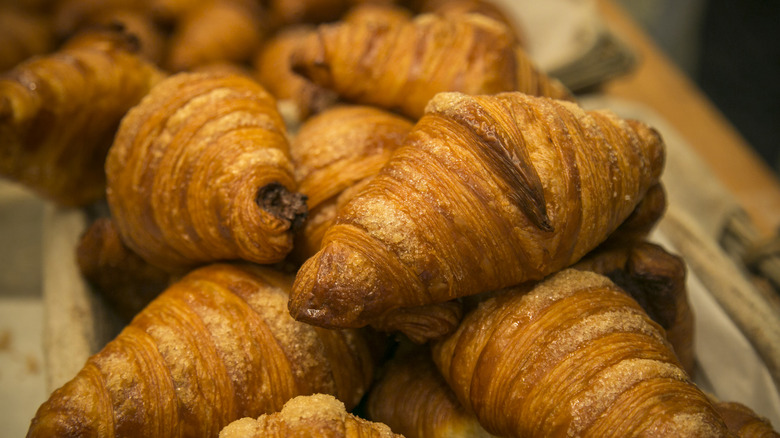 Croissants piled together on a table