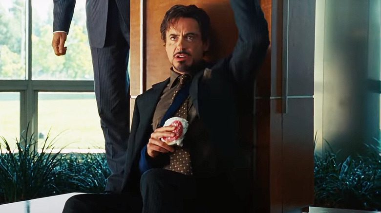 Tony Stark holding wrapped cheeseburger