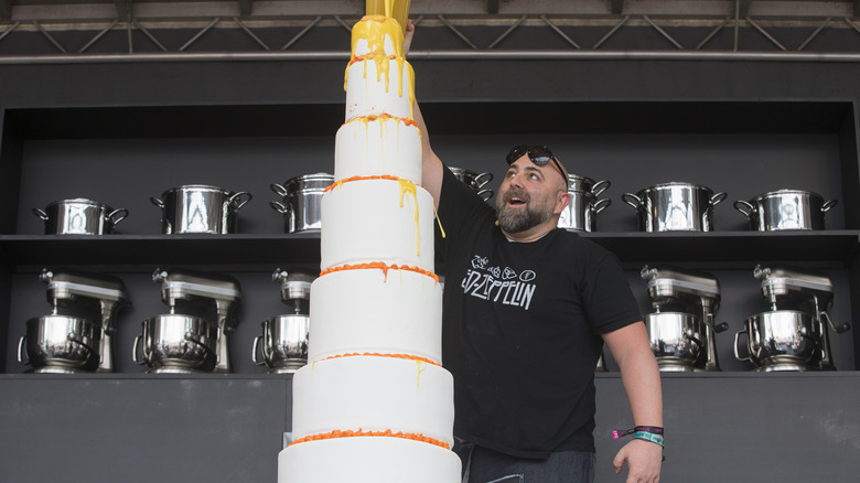 Duff Goldman pouring frosting on cake