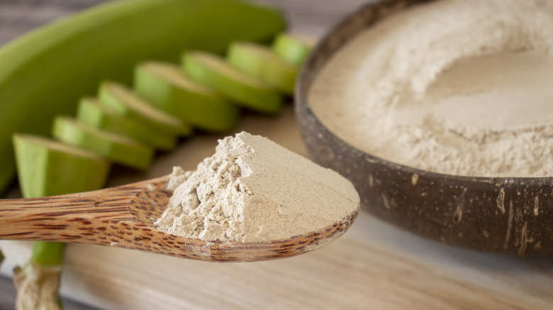 Banana flour in wooden spoon