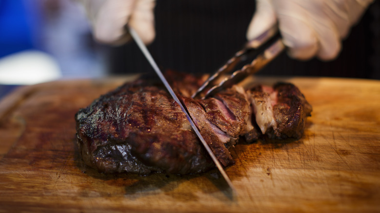 Person slicing steak