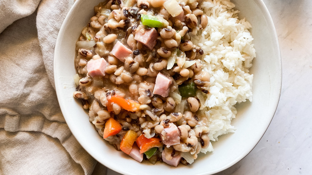 hoppin john in a white bowl with rice and ham