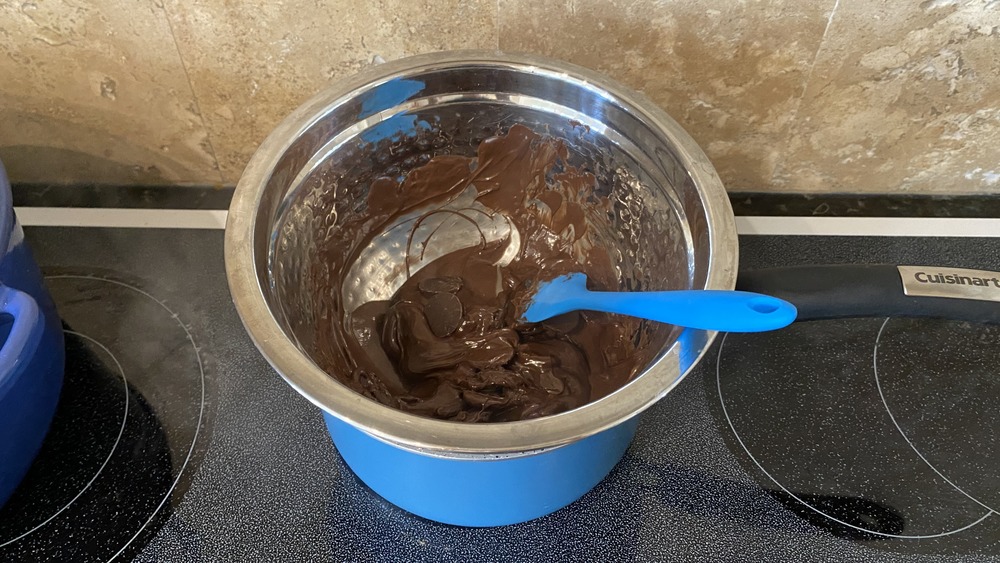 tempering chocolate on the stove for hot chocolate bombs