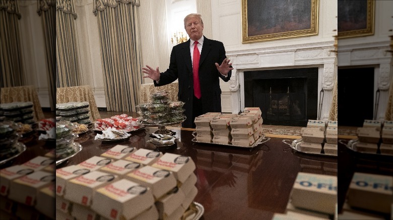 Donald Trump standing by fast food 