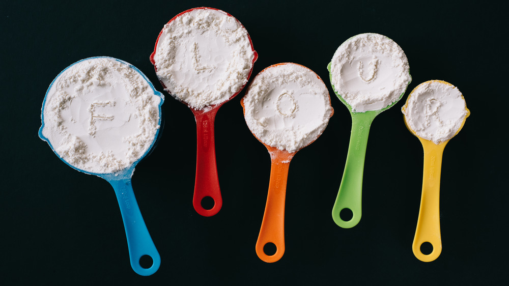 Measuring cups filled with flour